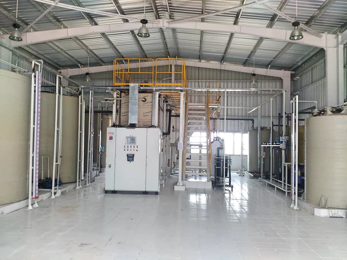 Waste water treatment hall with storage tanks, an access platform and a central control panel